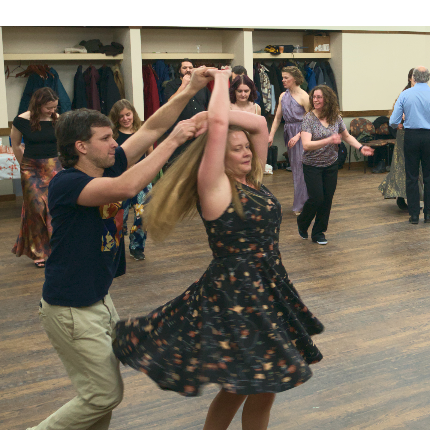 man leading a woman in a salsa spin