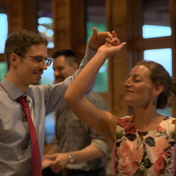 a woman about to turn under a man's hand as they partner dance