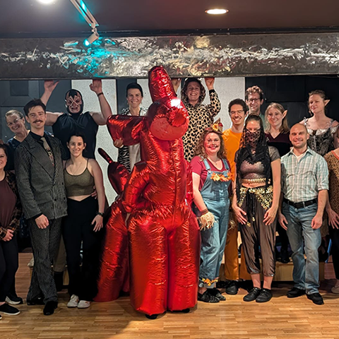 a group of Baila UP dancers smiling and dressed in Halloween costumes posing for a picture
