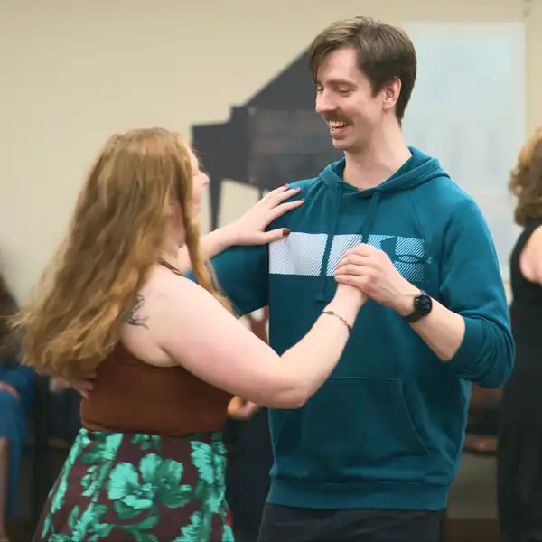 two people partner dancing and smiling