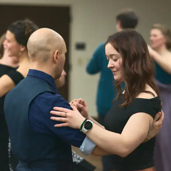 two young people in formal wear partner dancing