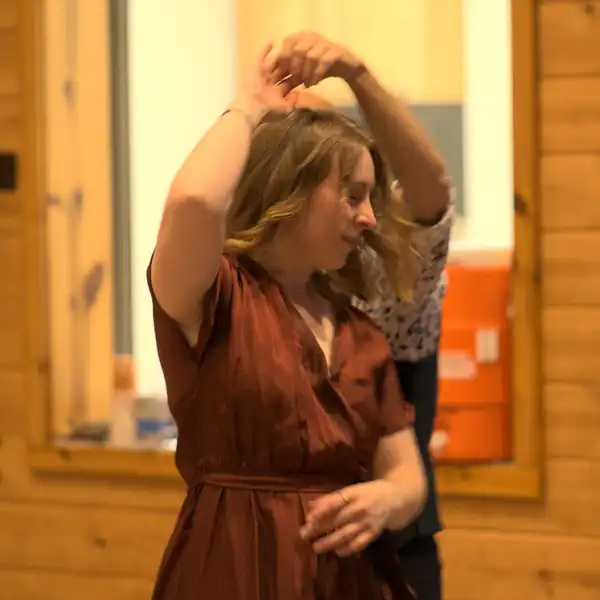 a woman spinning under a man's arm as they dance